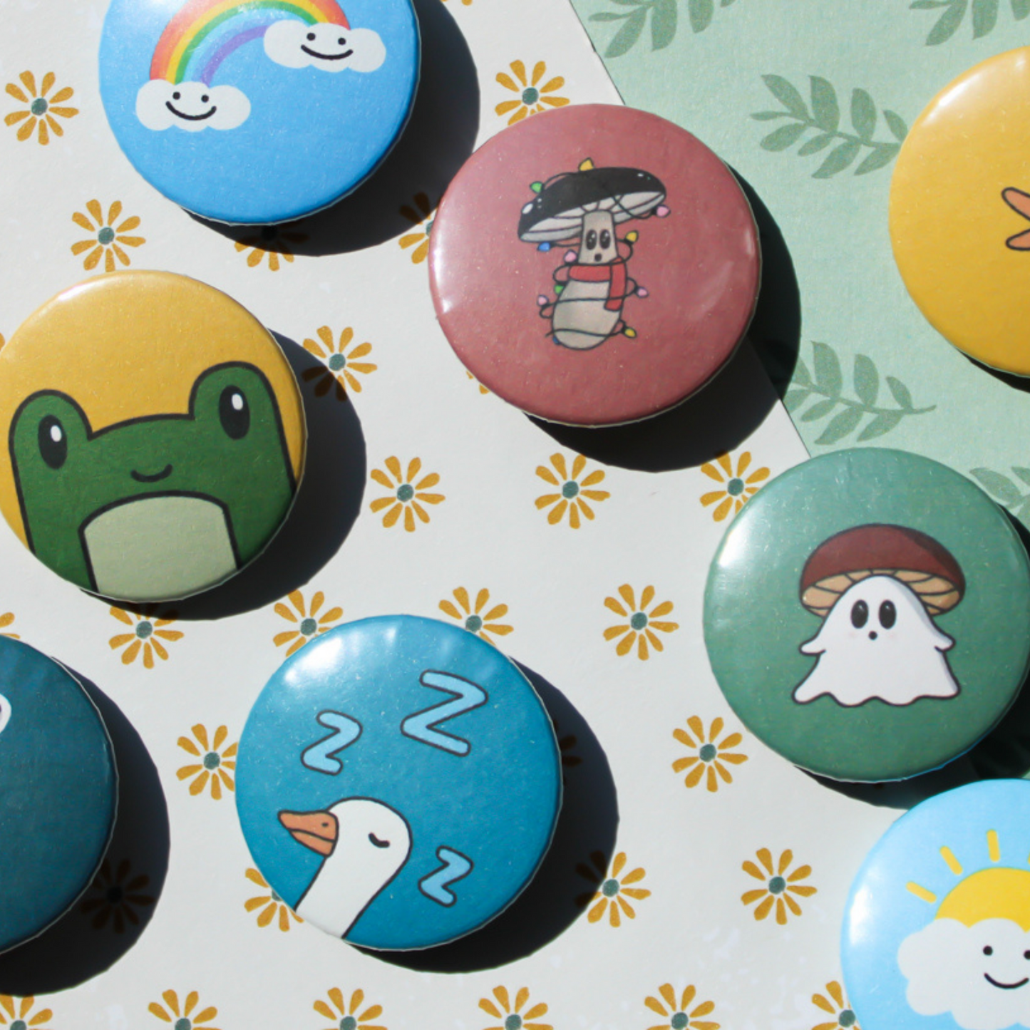 A flower and leaf patterned background with circle buttons spread across featuring geese, rainbow clouds, mushrooms, and frogs.