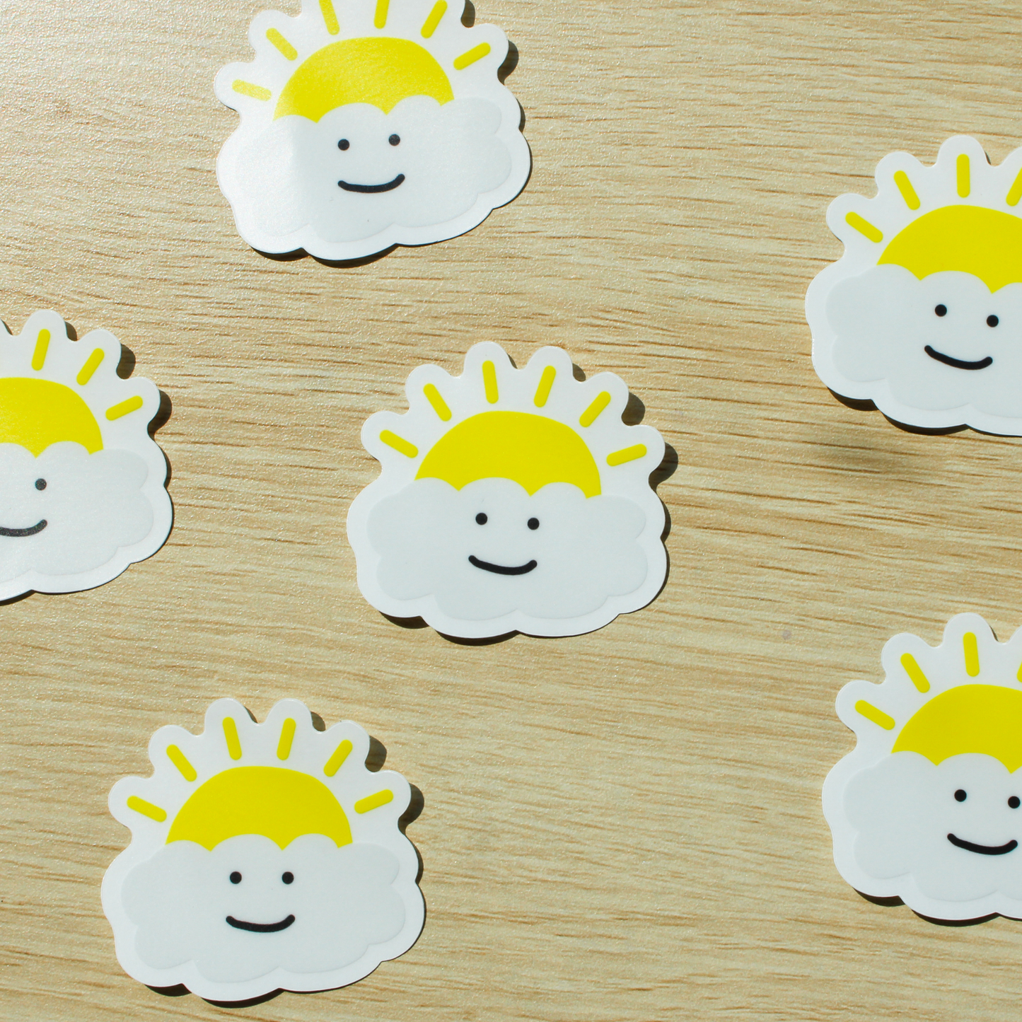 A wooden background with scattered happy cloud stickers.