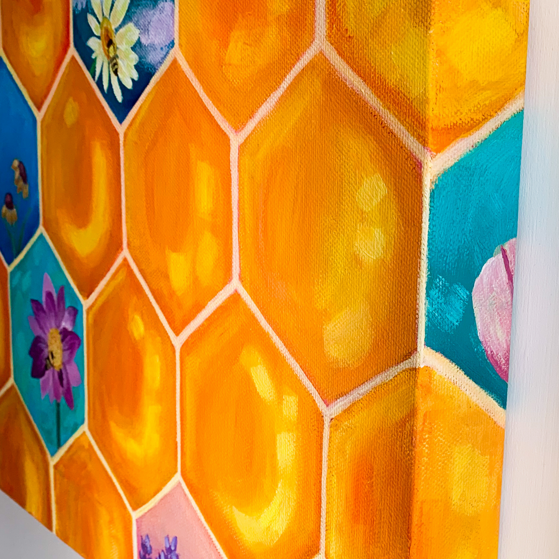 The side of the honeycomb painting showing another honeycomb that's blue with a tulip blooming.