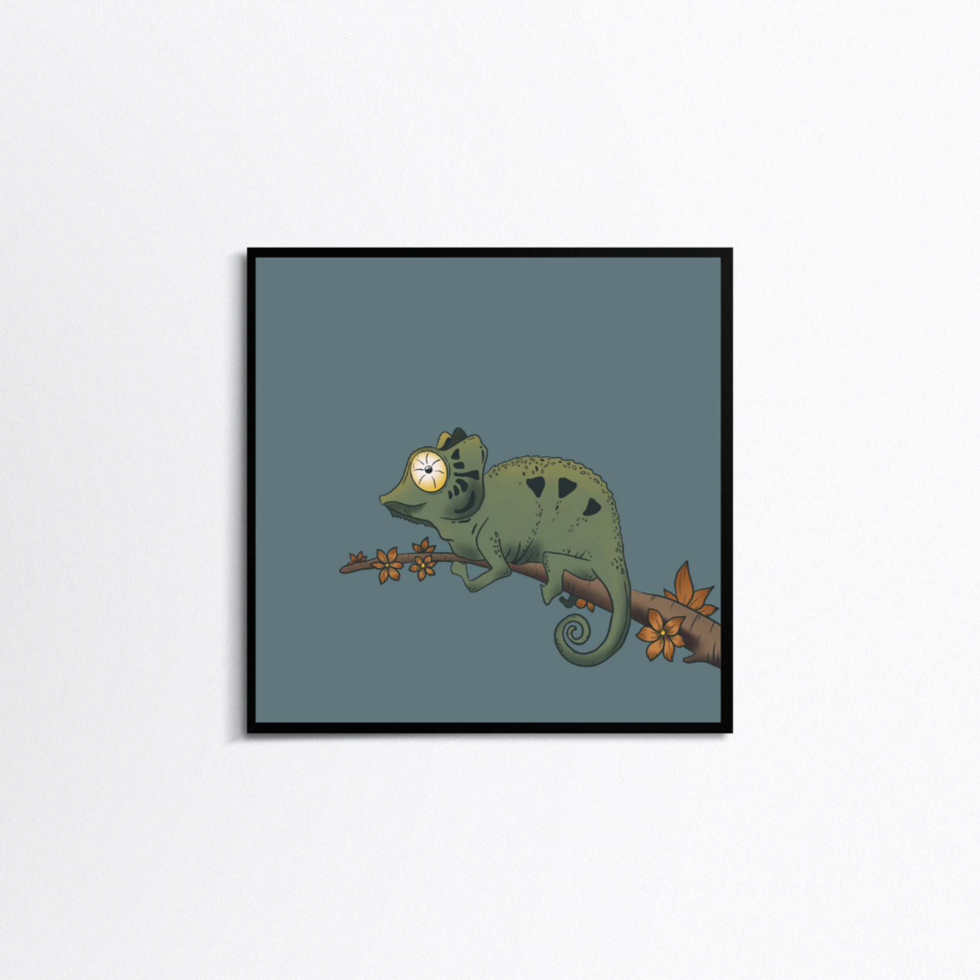 White background with a square black frame. In the frame is a print with a pale blue background with a green chameleon on a brown branch with blooming orange flowers.
