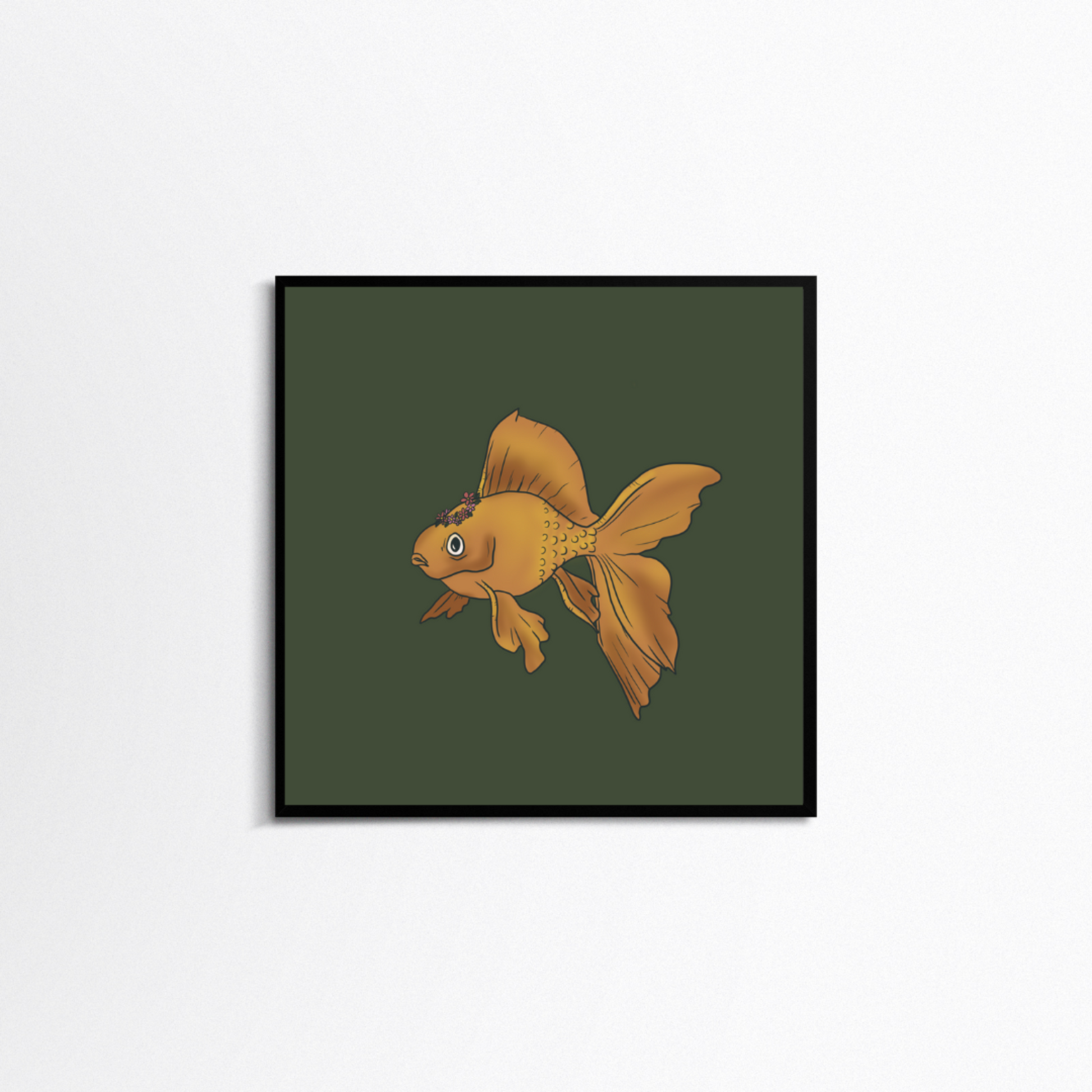 White background with a square black frame. In the frame is a print with a moss green background and a yellow goldfish in the middle. On the top of the goldfish is a pink flower crown.